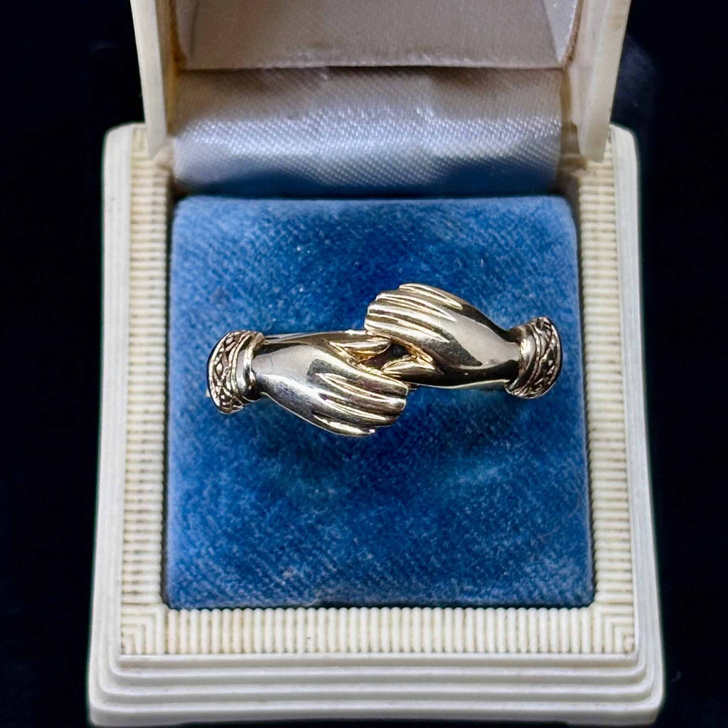 Victorian fede gimmel ring in yellow gold displayed in antique box showing clasped hands design.