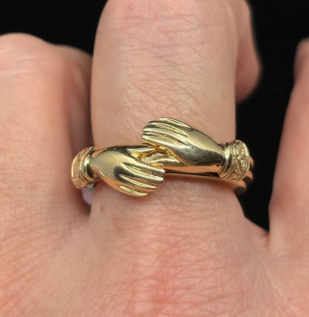Victorian gold fede gimmel ring worn on finger showing scale and craftsmanship