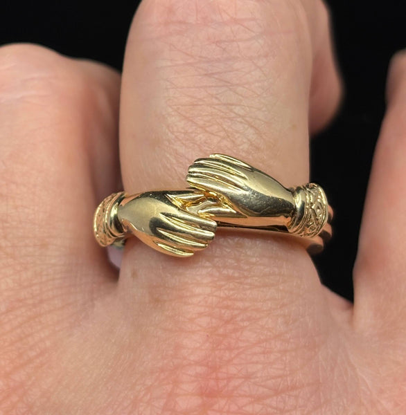 Victorian gold fede gimmel ring worn on finger showing scale and craftsmanship