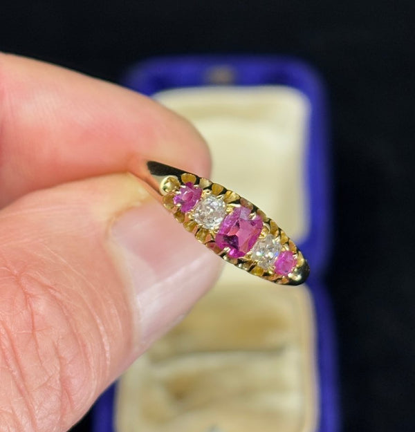 Close-up of a Victorian ring set with pink sapphires and old mine cut diamonds.