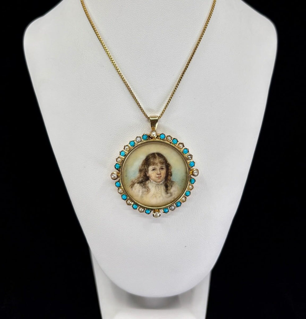 Close-up of hand-painted portrait miniature on ivory set in a 15ct gold Victorian locket framed by turquoise and natural pearls