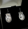 Victorian sterling silver earrings featuring intricate chinoiserie bird motifs.