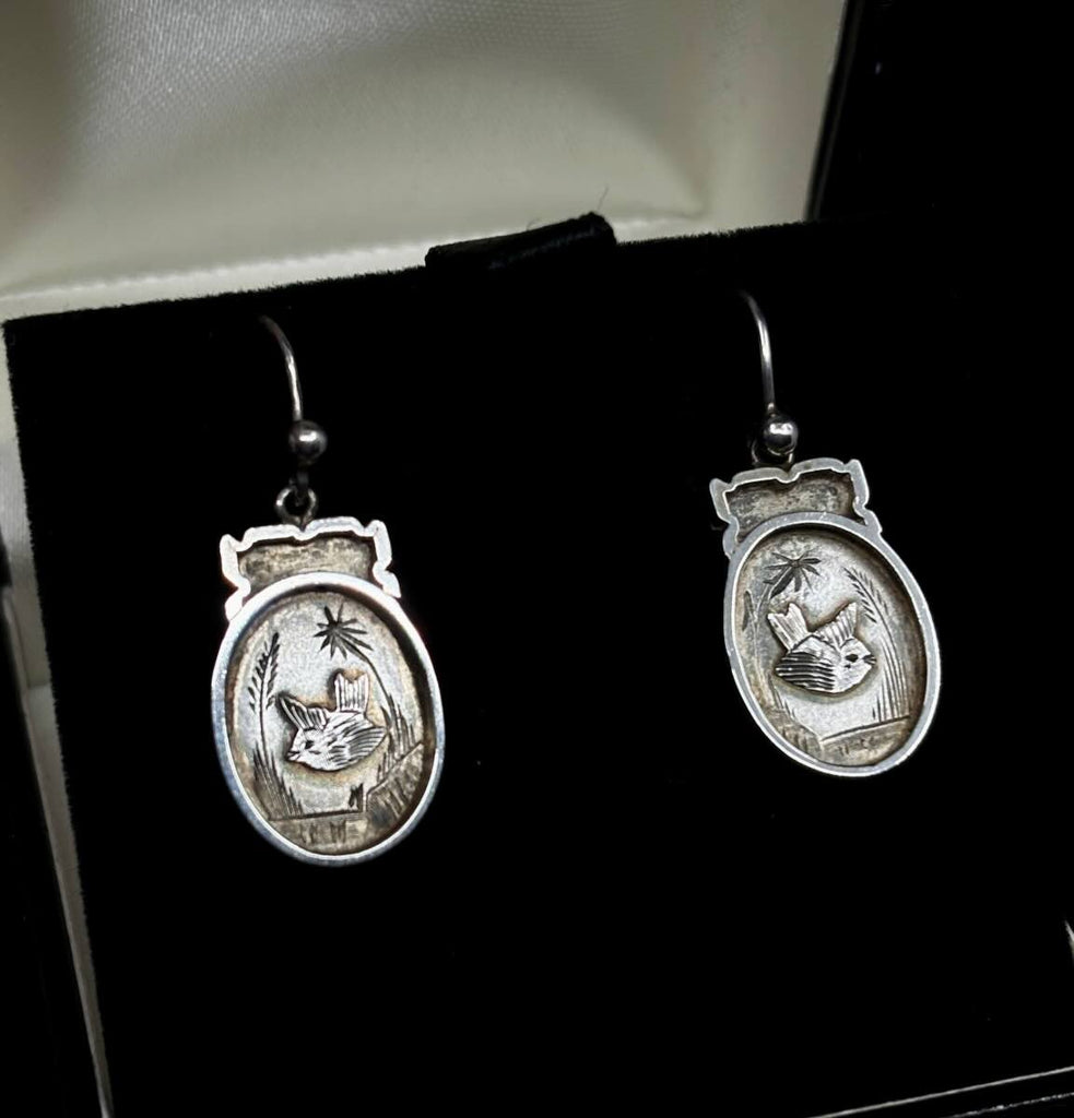 Victorian sterling silver earrings featuring intricate chinoiserie bird motifs.