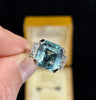 Vintage 1950s emerald-cut aquamarine ring 8.70ct set in 18ct white gold with six single-cut diamond shoulders — classic mid-century cocktail ring.
