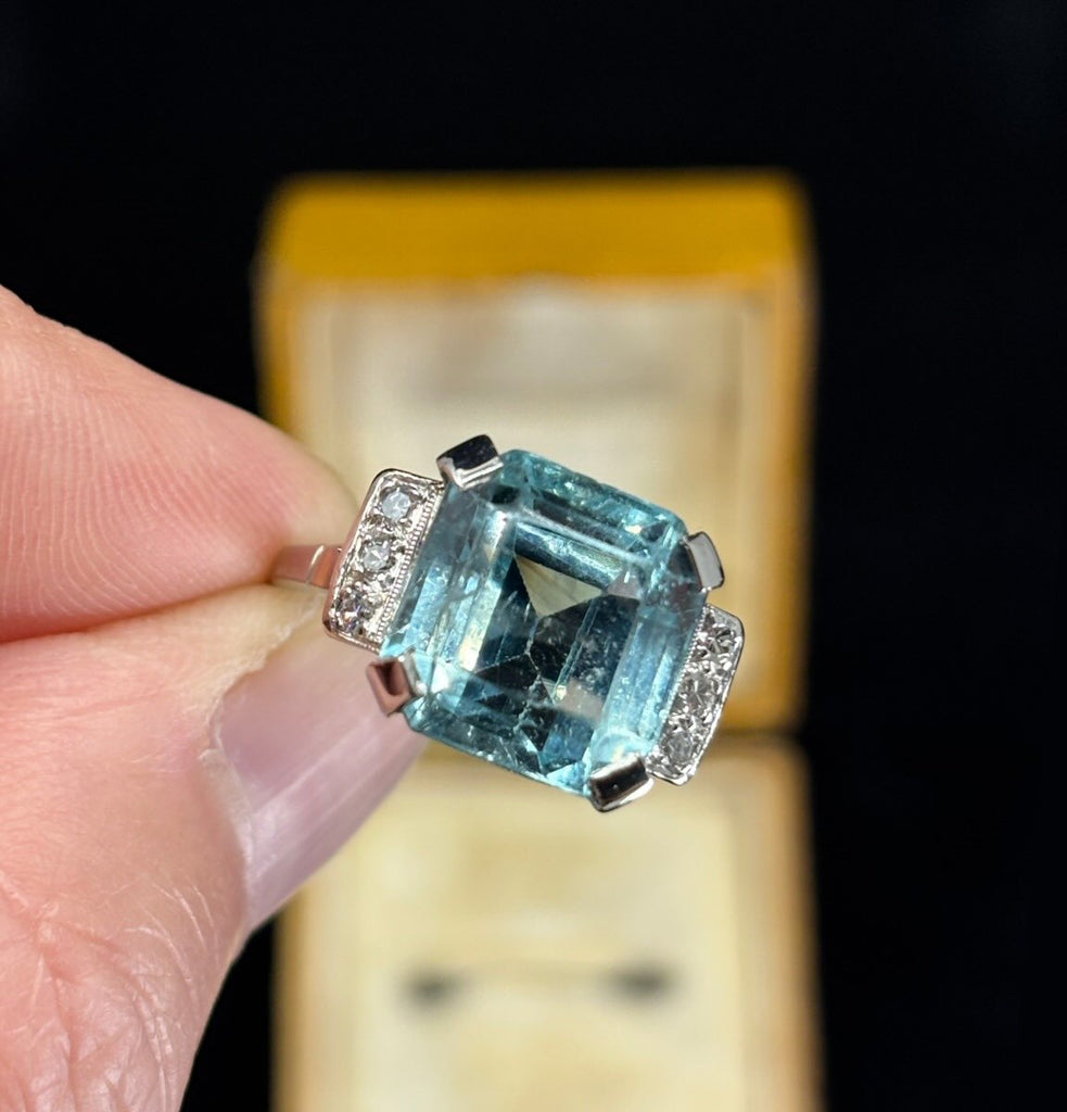 Vintage 1950s emerald-cut aquamarine ring 8.70ct set in 18ct white gold with six single-cut diamond shoulders — classic mid-century cocktail ring.