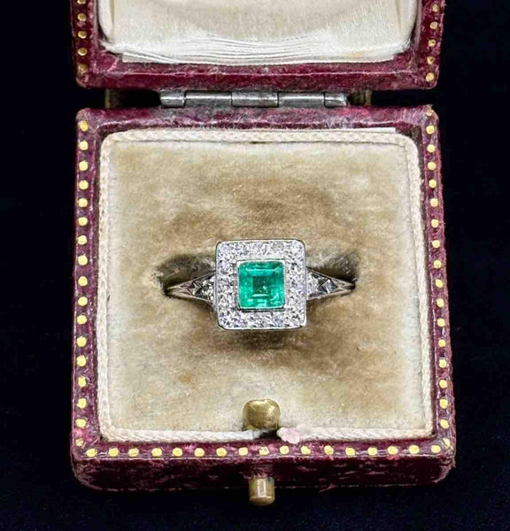 A stunning vintage 1950s emerald and diamond ring with a platinum setting.