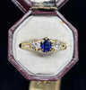 Vintage 1950s three‑stone ring with 0.50ct oval royal blue sapphire flanked by two 0.40ct G VS round brilliant diamonds set in 18ct yellow gold.