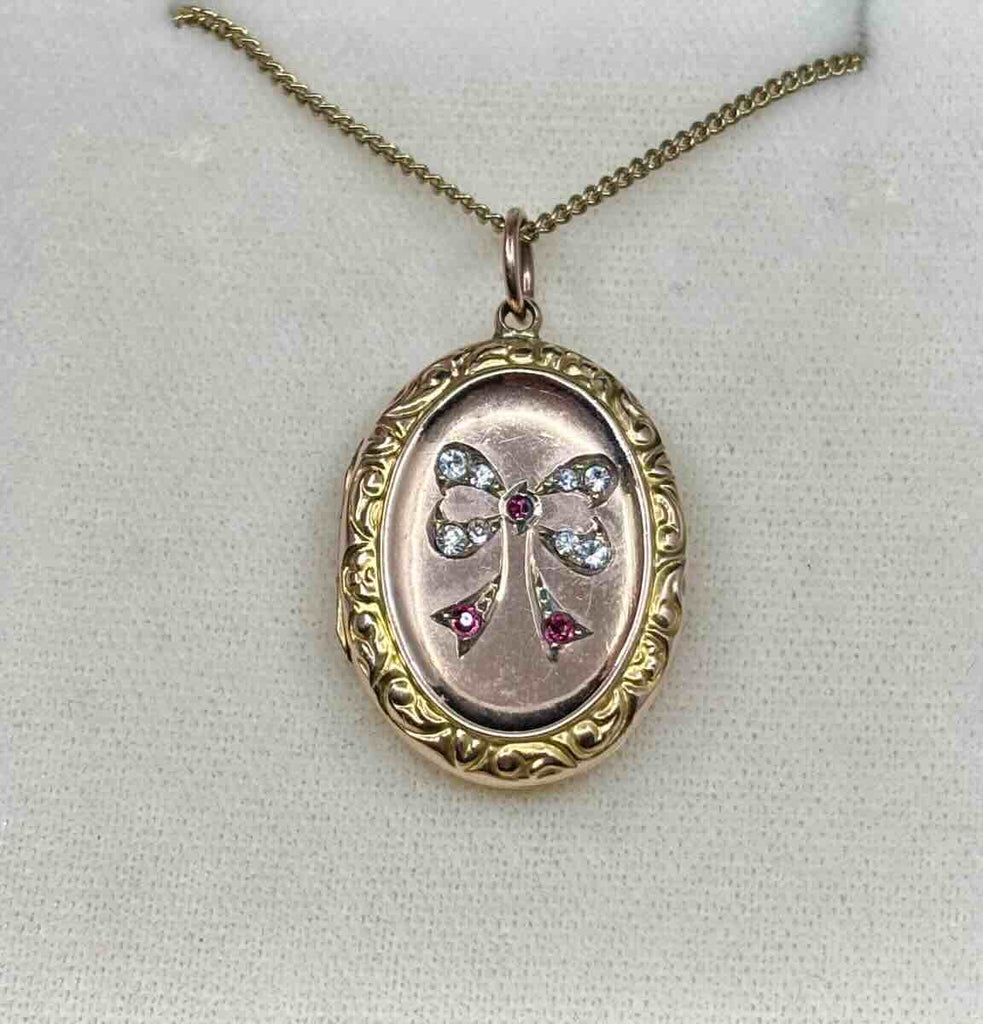 Vintage 9ct yellow gold locket showcasing a beautiful bow motif, emblematic of the Victorian era.