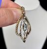 Vintage Art Nouveau pendant featuring a light blue oval aquamarine, natural seed pearls and old‑cut diamonds, circa 1905.