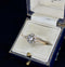 Vintage diamond posy cluster ring displayed in a blue velvet ring box.