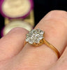 a side view of the low profile of the 1930s flower cluster ring sitting flush on the finger