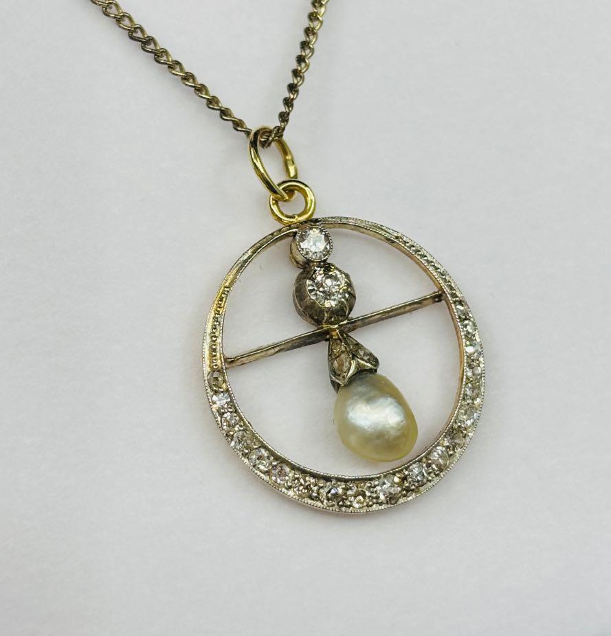 Unique vintage pearl and diamond jewelry pendant, showcasing intricate craftsmanship from the Edwardian era, circa 1905.