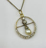 Unique vintage pearl and diamond jewelry pendant, showcasing intricate craftsmanship from the Edwardian era, circa 1905.