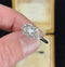 Vintage Art Deco diamond ring displayed elegantly in a classic jewelry box.