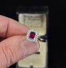Vintage ruby and diamond cluster ring from the 1920s, set in platinum with an 18ct white gold band, showcasing a rich red ruby.