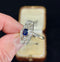 Vintage 1930s Art Deco ring featuring a tonneau shape with a cushion cut sapphire and old cut diamonds.