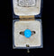Elegant 1920s ring featuring a stunning turquoise and diamond ring, emphasising the rich color of the turquoise and the sparkle of the diamonds.
