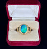 Close-up of a vintage 1940s ring featuring a vibrant oval black opal set in 18ct yellow gold."