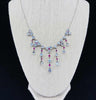 Front view of a vintage 1920s moonstone and ruby fringe necklace in sterling silver, showcasing Art Deco elegance.