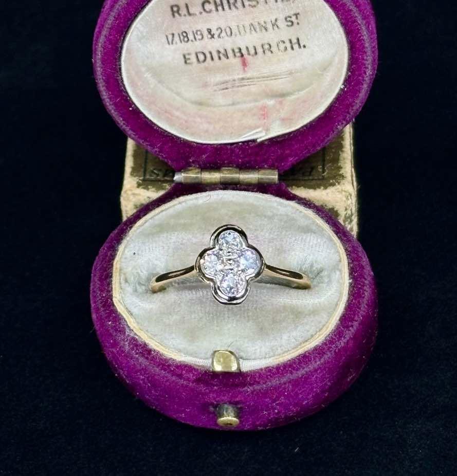 Exquisite quatrefoil ring with sparkling diamonds, showcasing Gothic revival style in an ornate jewelry case.